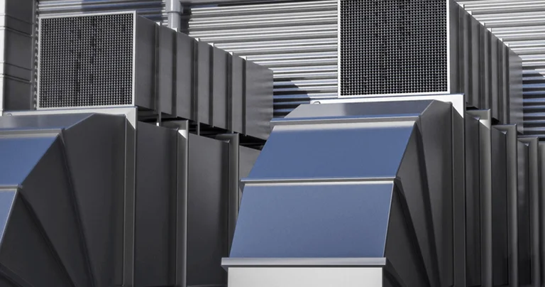 Three modern air conditioning units with blue panels and metal finishes, positioned against a corrugated wall.
