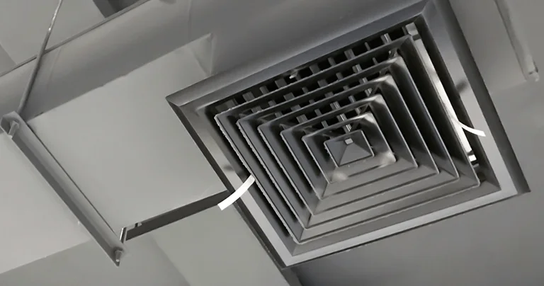 Detailed view of a metal wall vent, highlighting its surface and structural features.