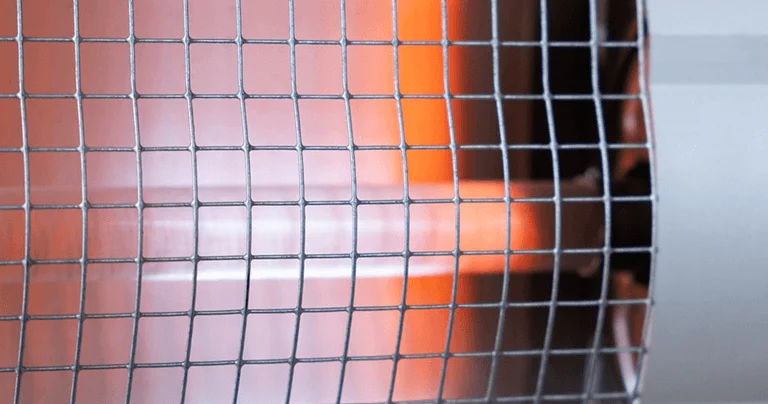 Close-up of a gas heater emitting a warm orange light, highlighting its design and functionality.