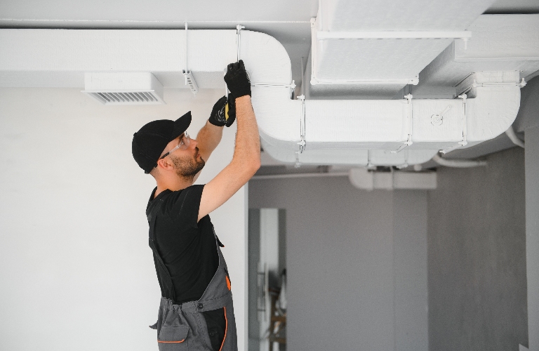 hvac services, worker install ducted pipe system for ventilation and air conditioning
