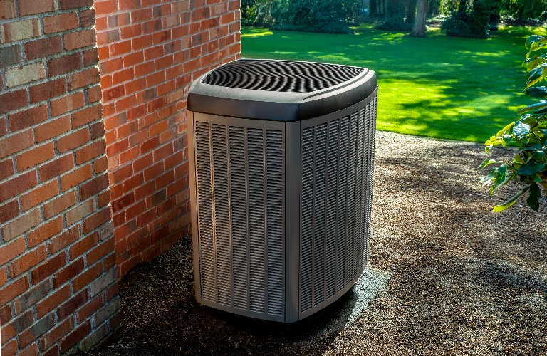 Heat pump HVAC unit on the side of house
