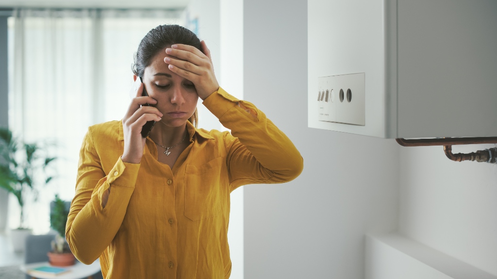 Worried woman calling to the repair service