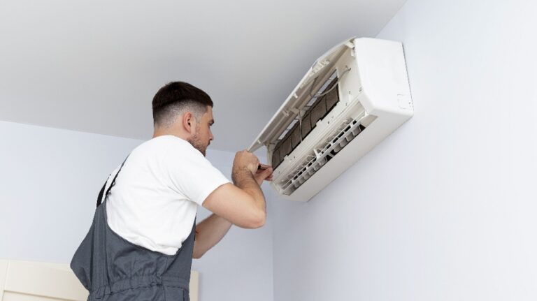 man installs an air conditioner