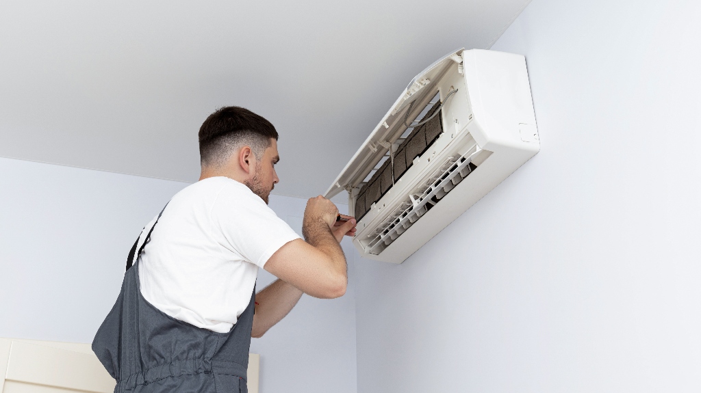 man installs an air conditioner